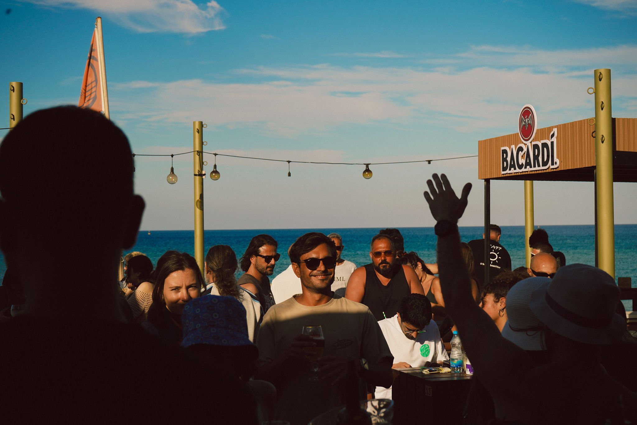 Beach bar crowd at sunset